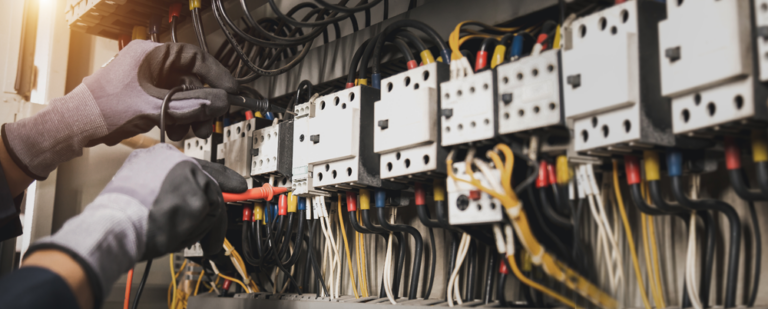 Technician working on industrial communication and control wiring