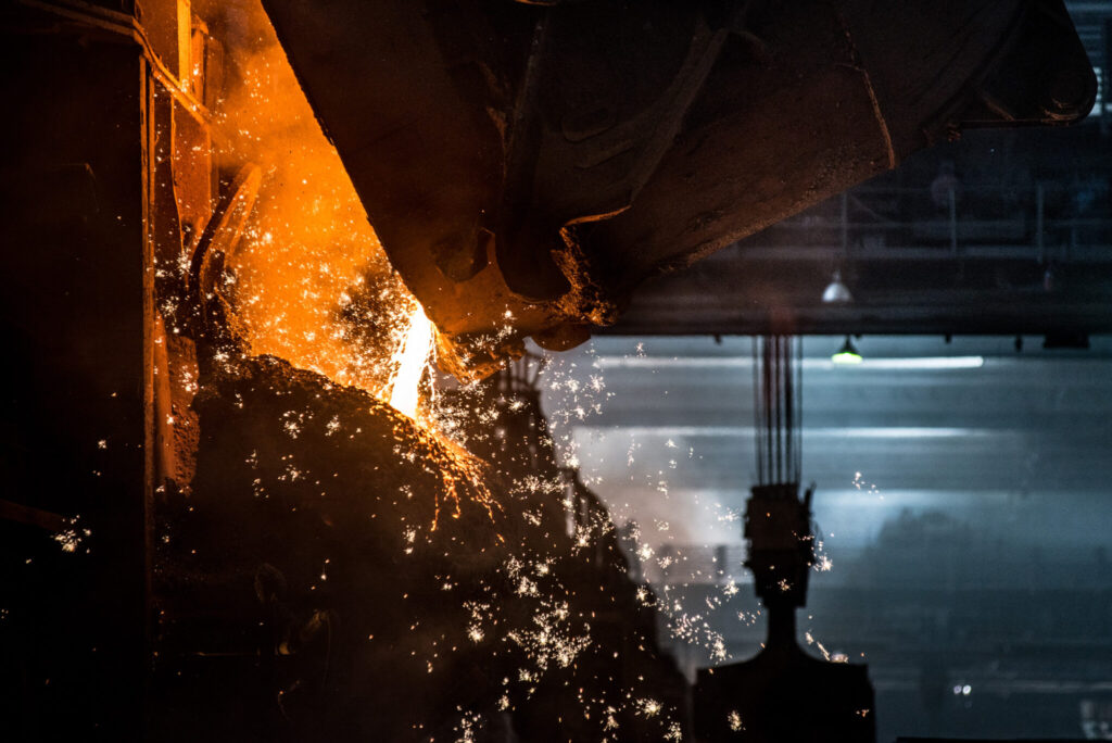 Pouring liquid metal in open hearth furance